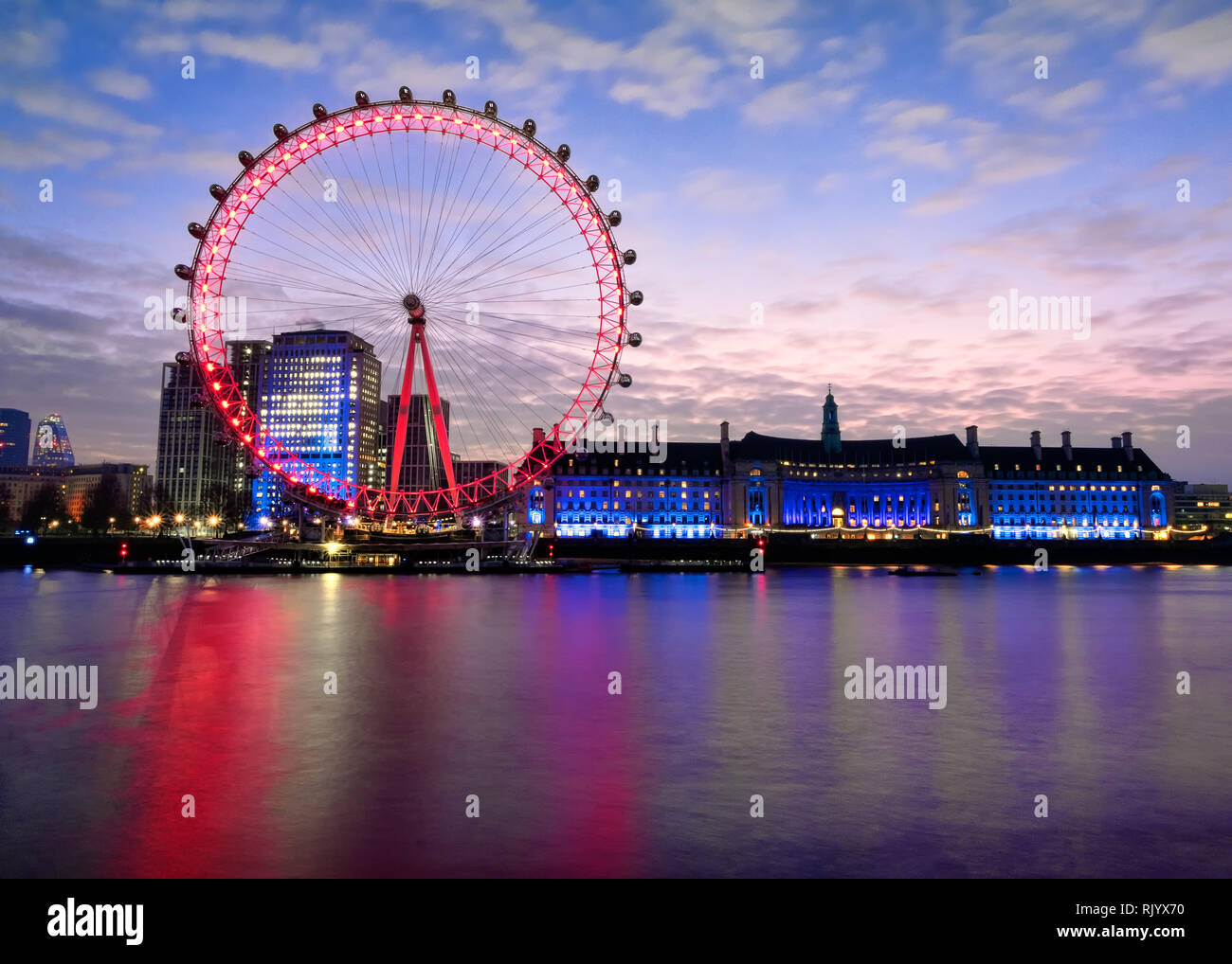 A twenty-second exposure, of the English London Eye and County Hall, taken to smooth out the River Thames. It was taken from near Westminster bridge. Stock Photo