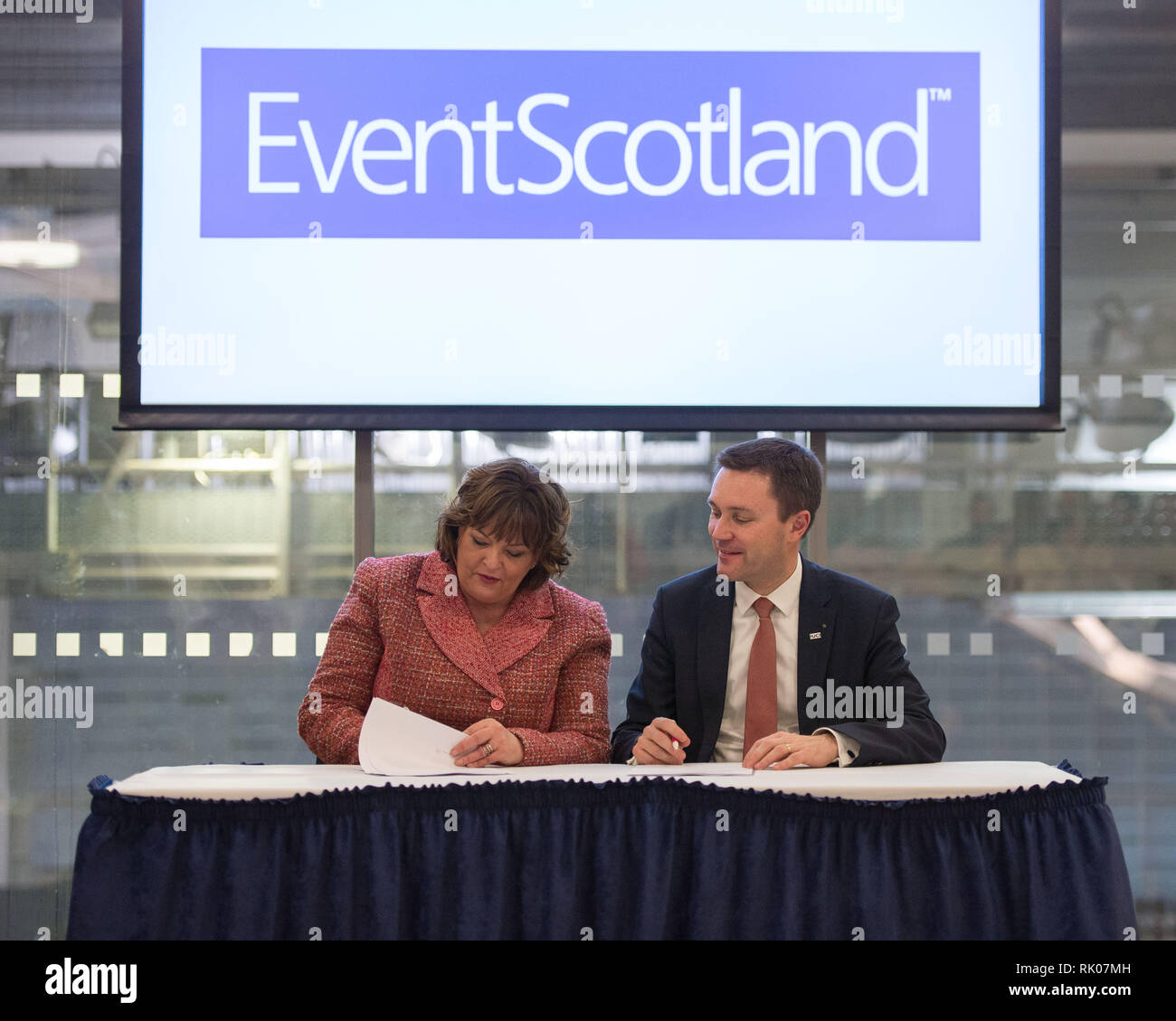 Glasgow, UK. 8 Feb 2019. (left) Fiona Hyslop MSP - Cabinet Secretary for Culture, Tourism and External Affairs, and (right) David Lappartient - President of the Union Cycliste Internationale signing an agreement.  A new multi-disciplinary cycling event will bring together 13 existing UCI cycling World Championships into one event to be held every four years, commencing in Glasgow and Scotland in 2023. Credit: Colin Fisher/Alamy Live News Stock Photo