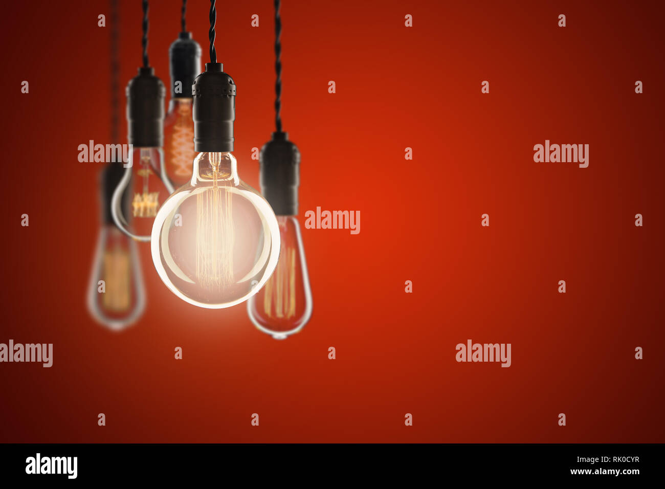 Idea and leadership concept Vintage bulbs on color wall background, copy space for text Stock Photo