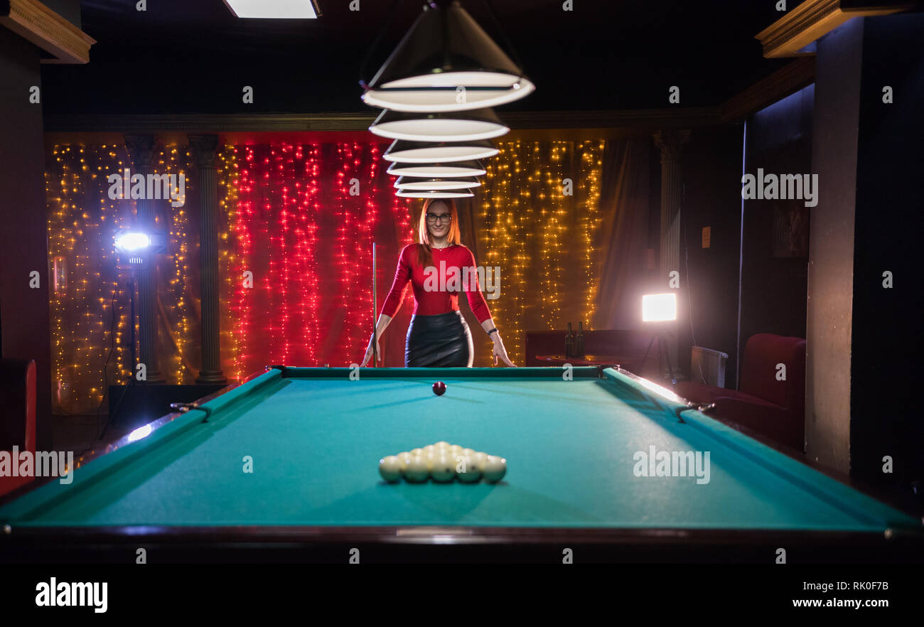 Billiard Club A Woman With Red Hair And Nice Figure Standing By The Table Beautiful Lighting