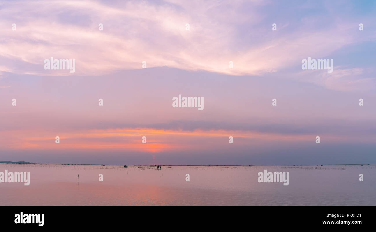 Beautiful sunset sky over the sea in the evening. Blue sky and purple ...