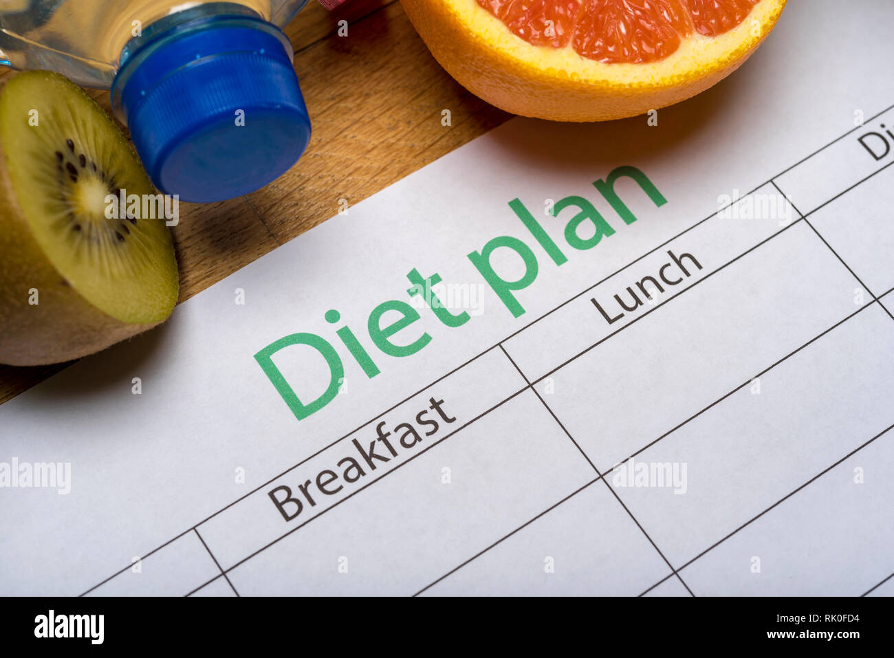 Diet plan, tape measure, water, diet of fresh fruits on the wooden floor. weight loss and ...