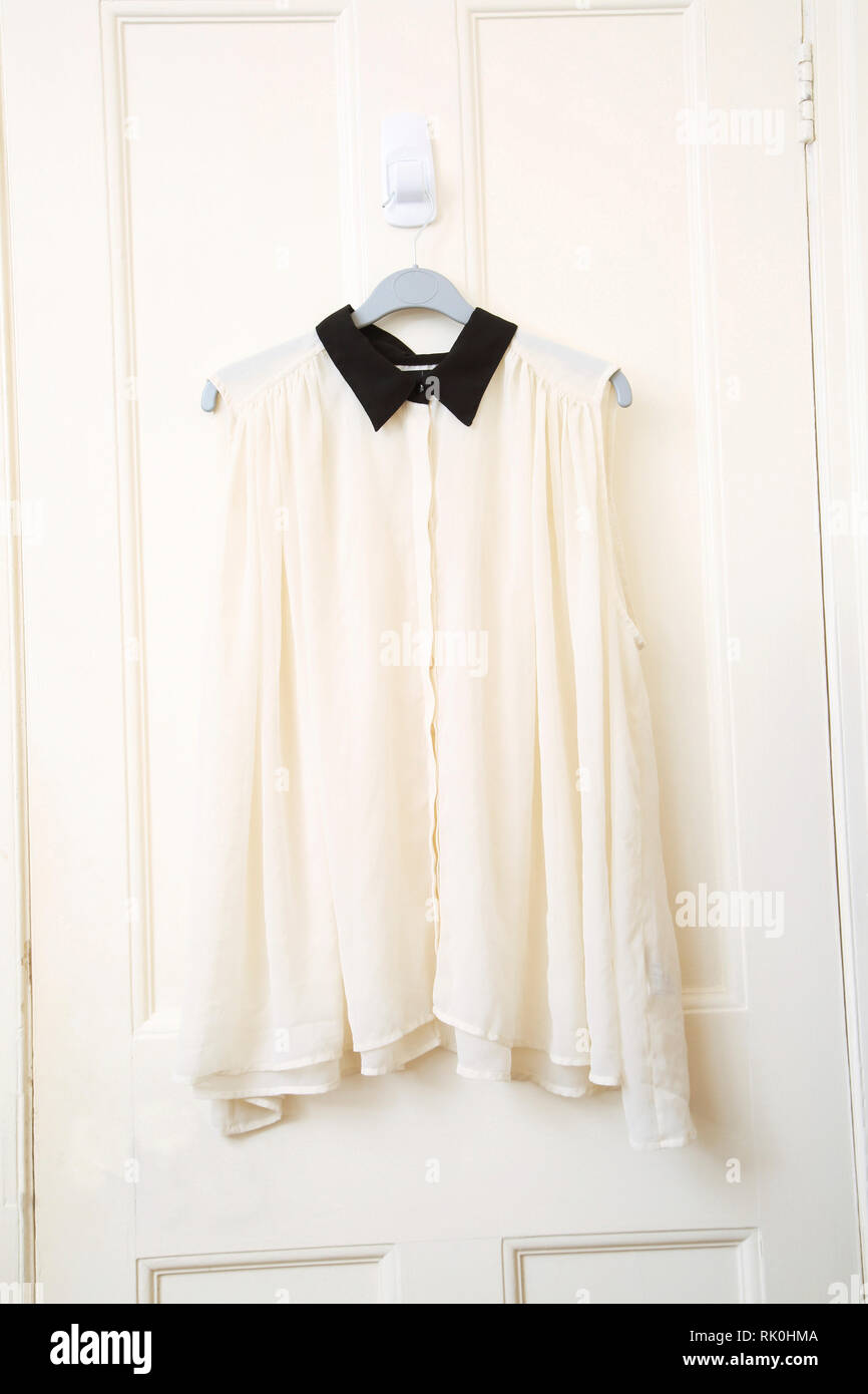 Sheer Sleevless Ivory Blouse with Black Collar Stock Photo