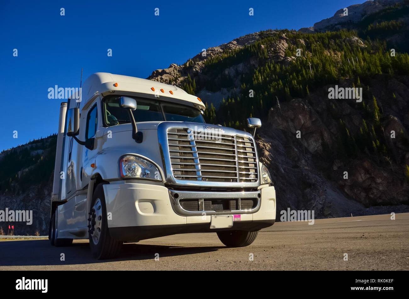 Side view of semi truck with Crowsnest mountain Stock Photo