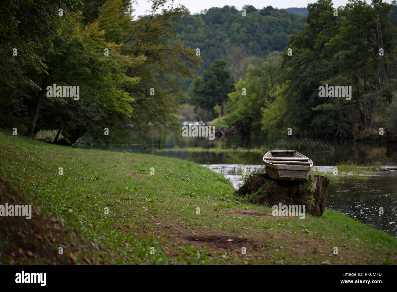 Lonely boat on the river bank Stock Photo - Alamy