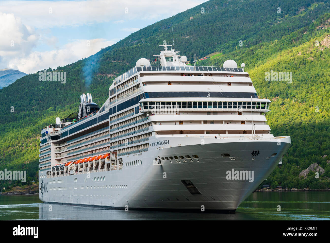 Large cruise ship sailing by mountains on fjord, Aurland, Norway, Europe Stock Photo