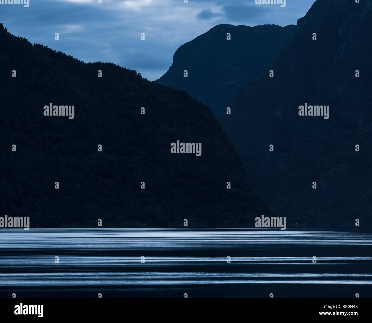Outline of mountains across fjord at dusk, Aurland, Norway, Europe Stock Photo