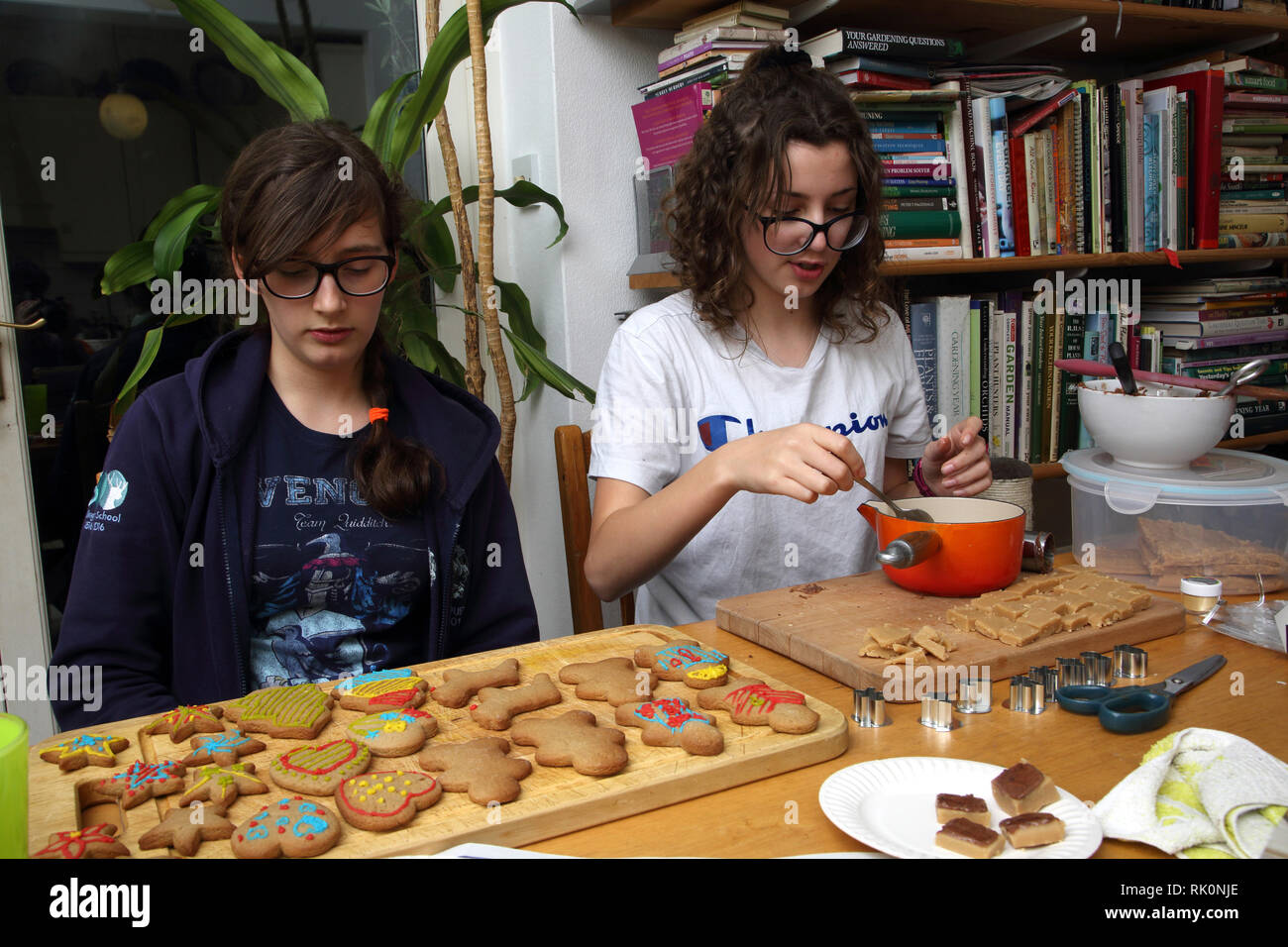 Sisters Making Christmas Cookies and Fudge Surrey England Stock Photo