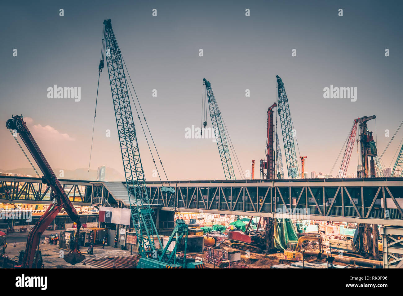 Industrial cityscape view with crane working at building construction. Hong Kong. Abstract futuristic landscape Stock Photo