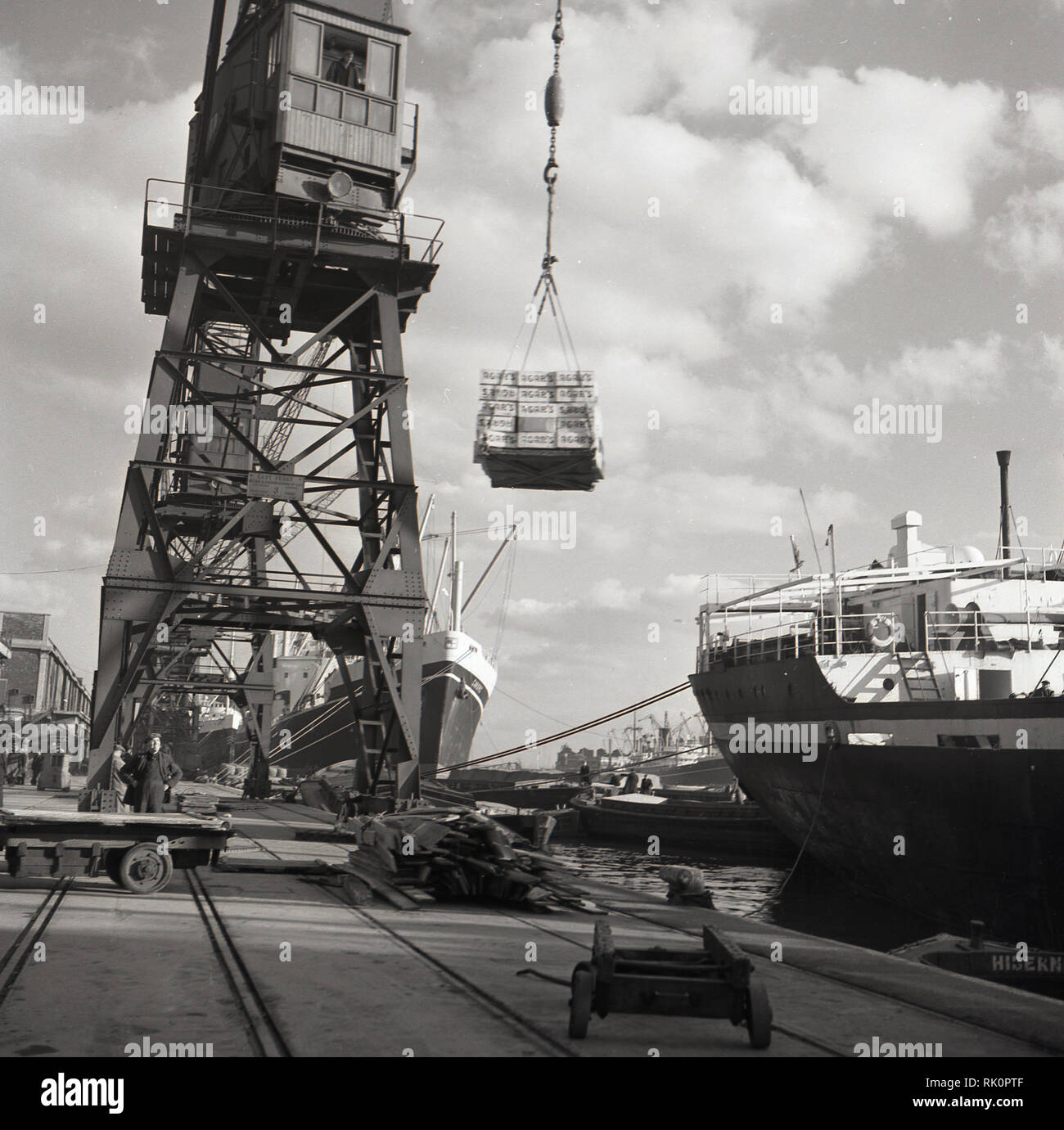 1950s, East Ferry, No 3, Isle of Dogs, London docks, a crane moving freight from ship, Agar's crates. At this time the docklands of London were working industrial places but declined from the 1960s onwards, as the larger ships could not be accomodated in the narrow waterways. Stock Photo