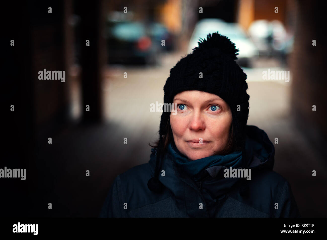 Beautiful hopeful adult caucasian woman portrait on the street on cold winter day Stock Photo