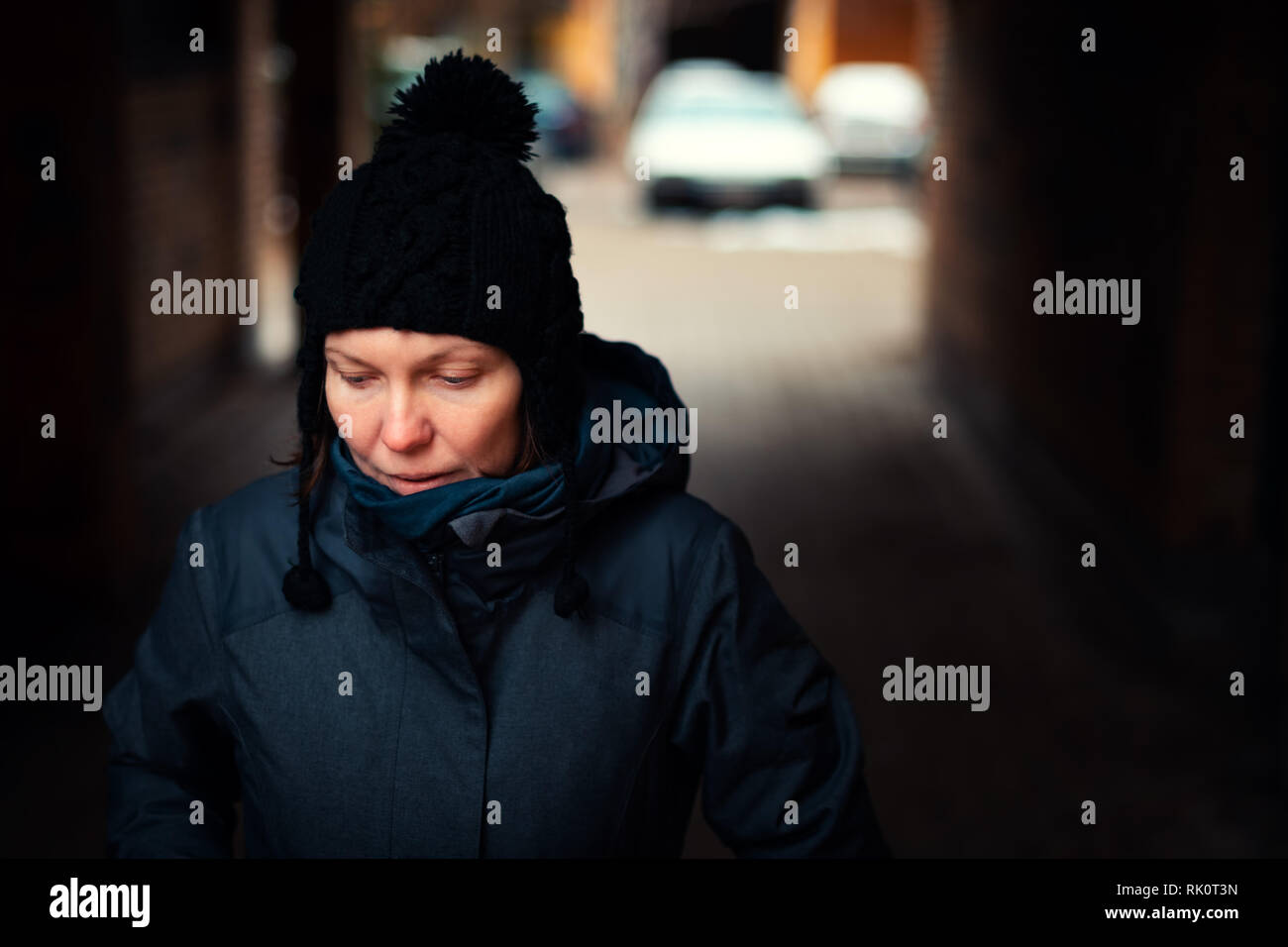 Beautiful hopeful adult caucasian woman portrait on the street on cold winter day Stock Photo