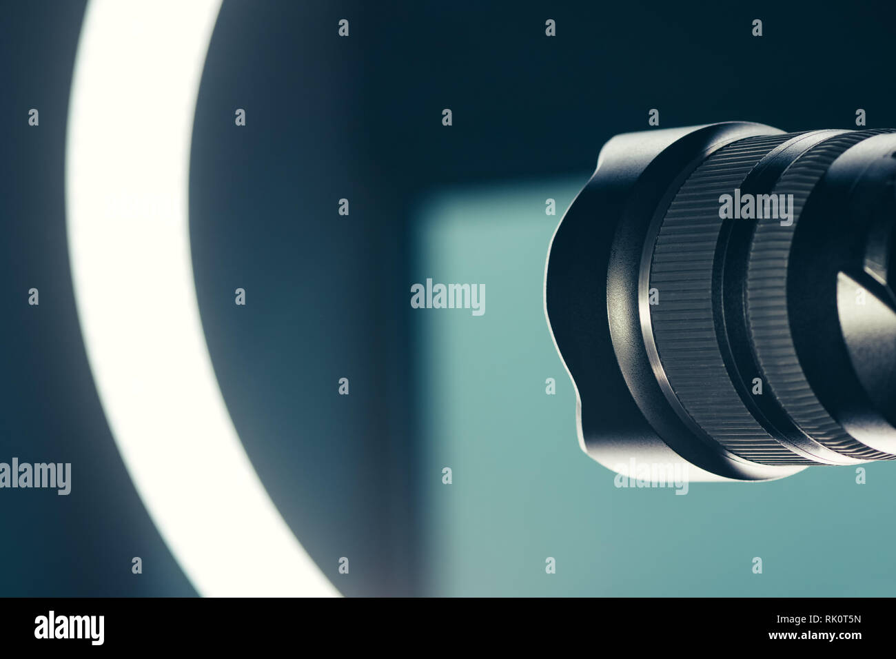 Camera lens and LED ring light in studio, photo and video production conceptual copy space Stock Photo