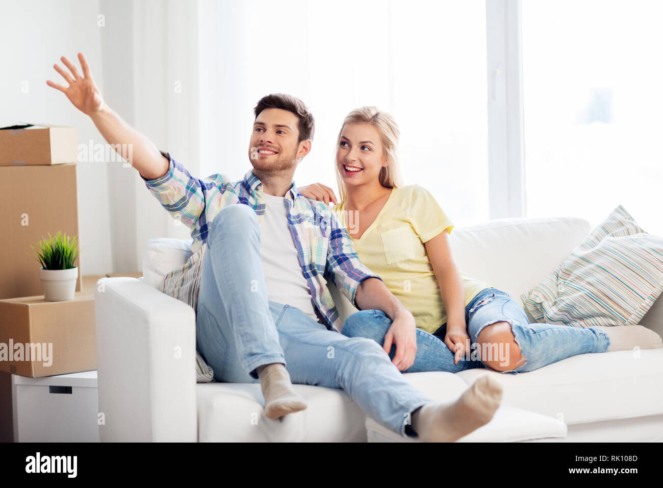 happy couple with cardboard boxes at new home Stock Photo - Alamy