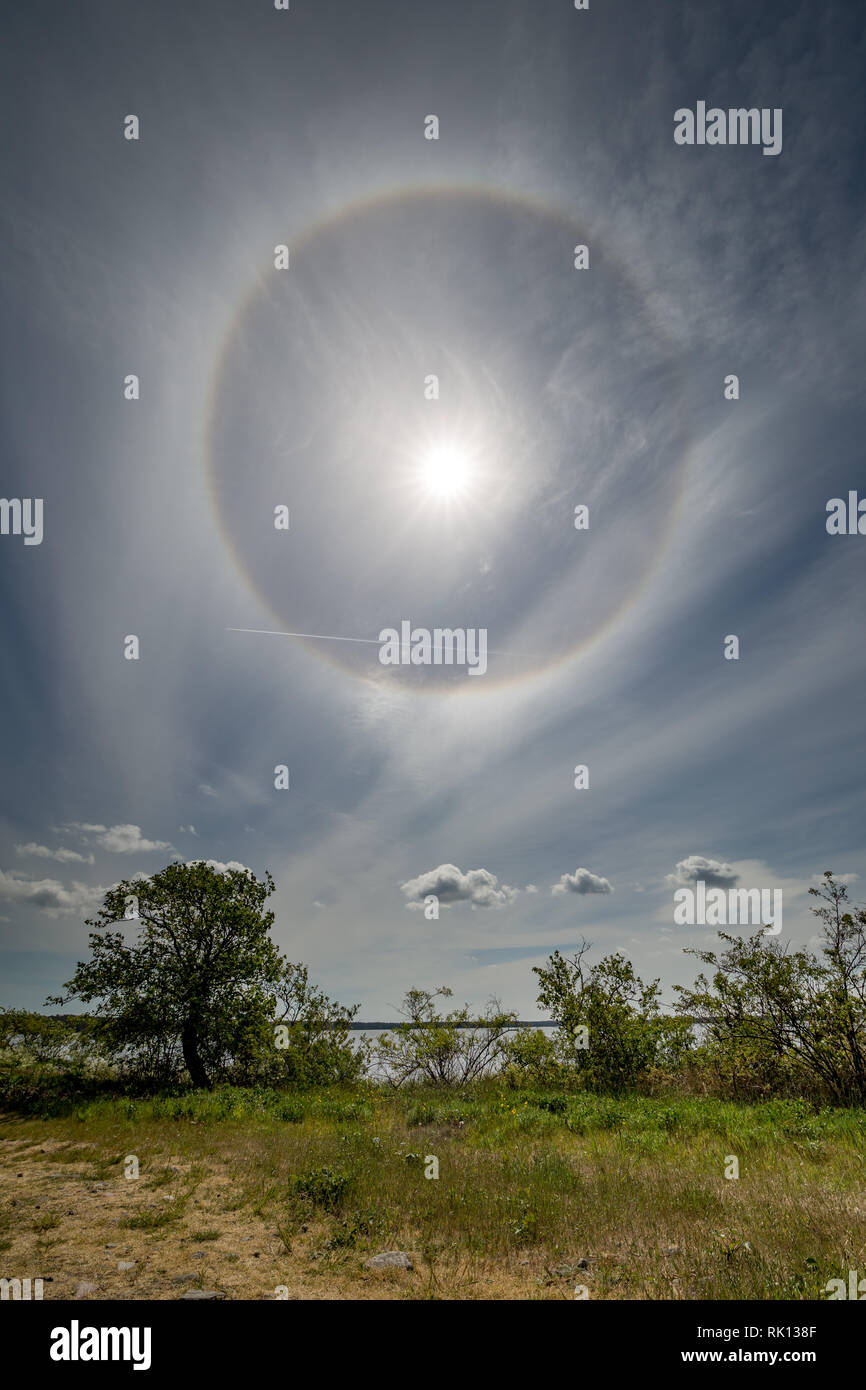 Halo around the sun in a layer of cirrostratus clouds over the Baltic sea viewed from the island of Öland, Sweden. Stock Photo