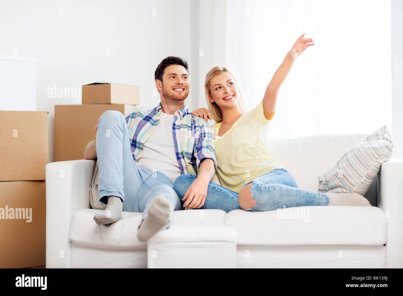 happy couple with cardboard boxes at new home Stock Photo - Alamy