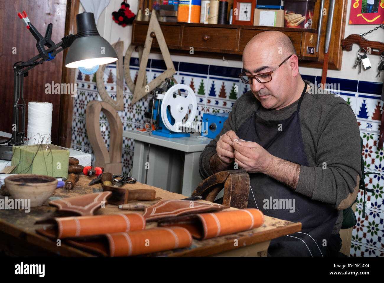 craftsman working the leather in his small workshop Stock Photo