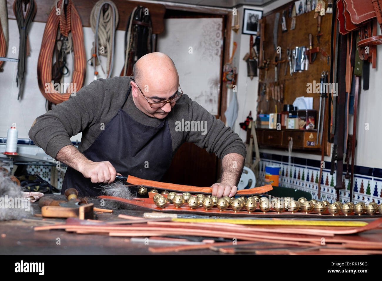 craftsman working the leather in his small workshop Stock Photo