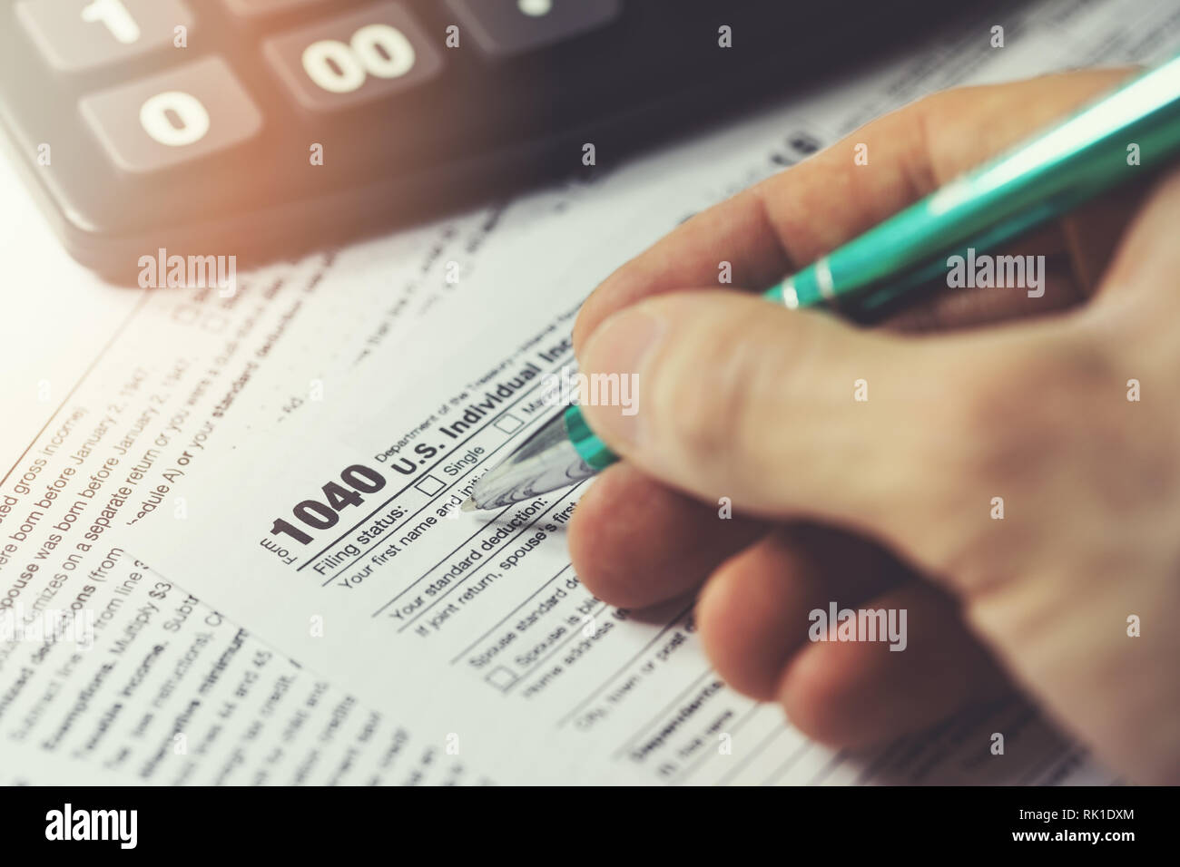 hand filing annual usa individual income tax return form 1040 Stock Photo
