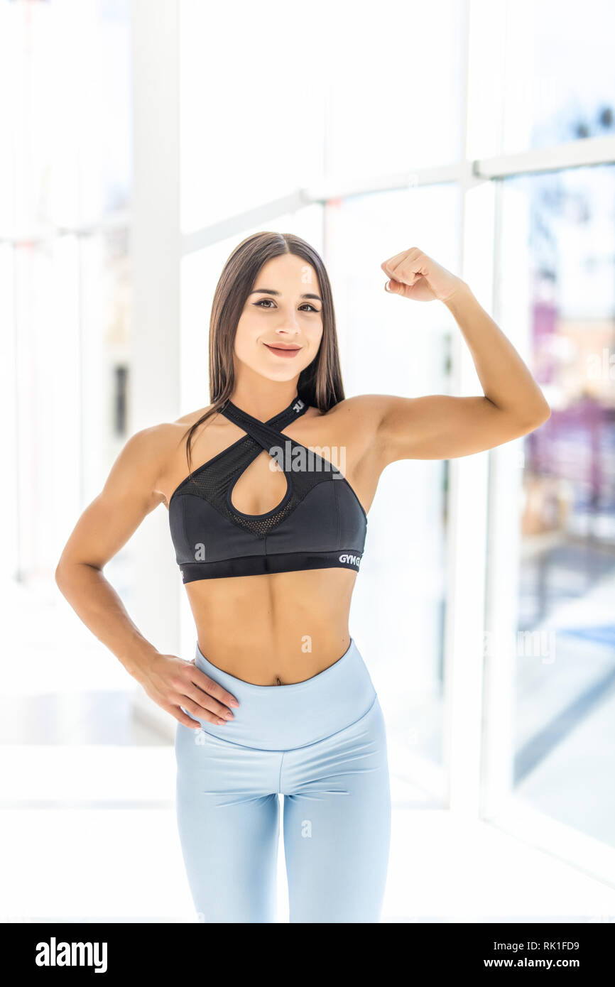 Beautiful strong muscular woman flexing her biceps and arm muscles. Female  Body Builder Stock Photo - Alamy