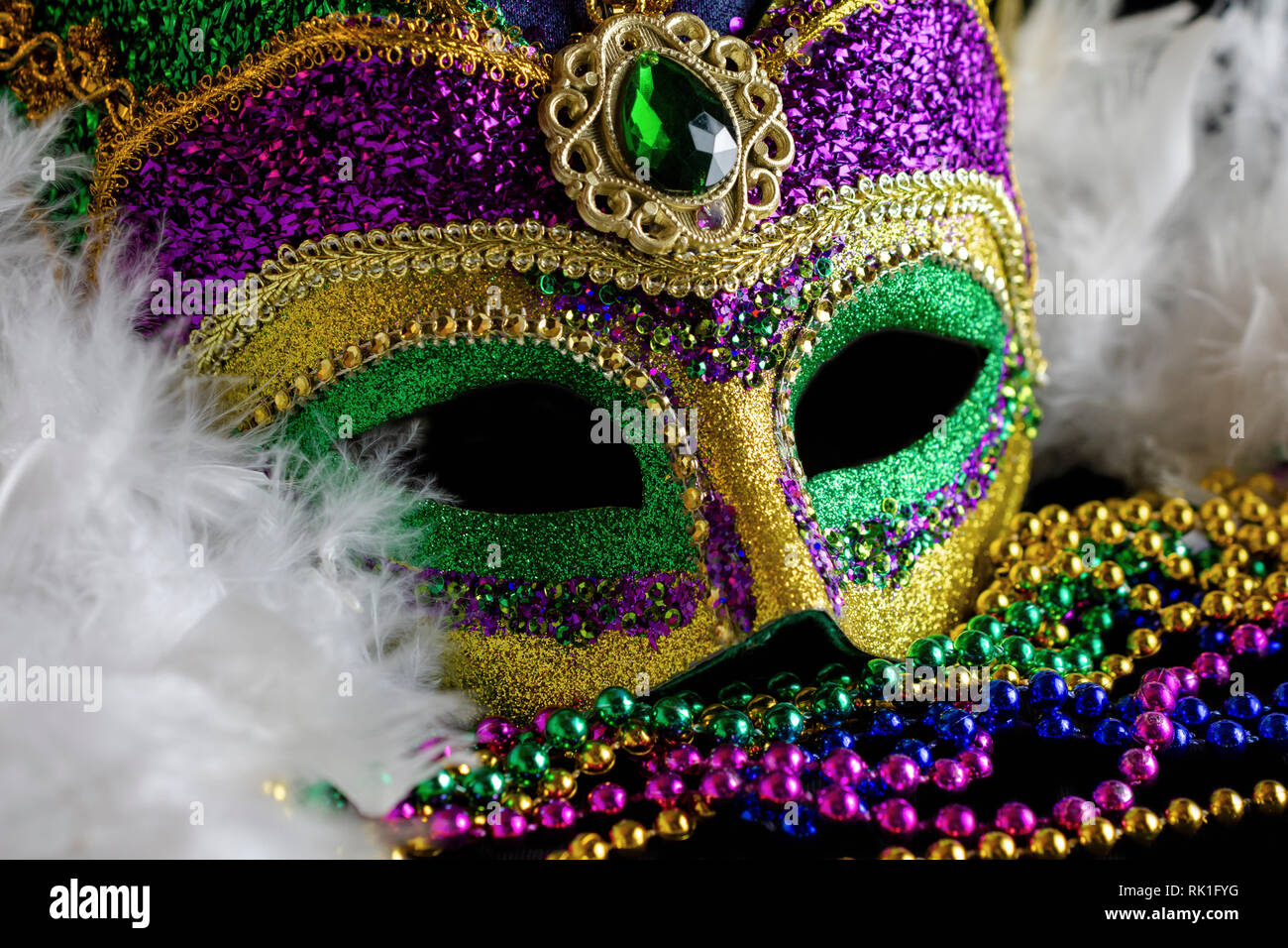 Mardi Gras Carnival Mask Feather Boa And Beads Over Blackboard