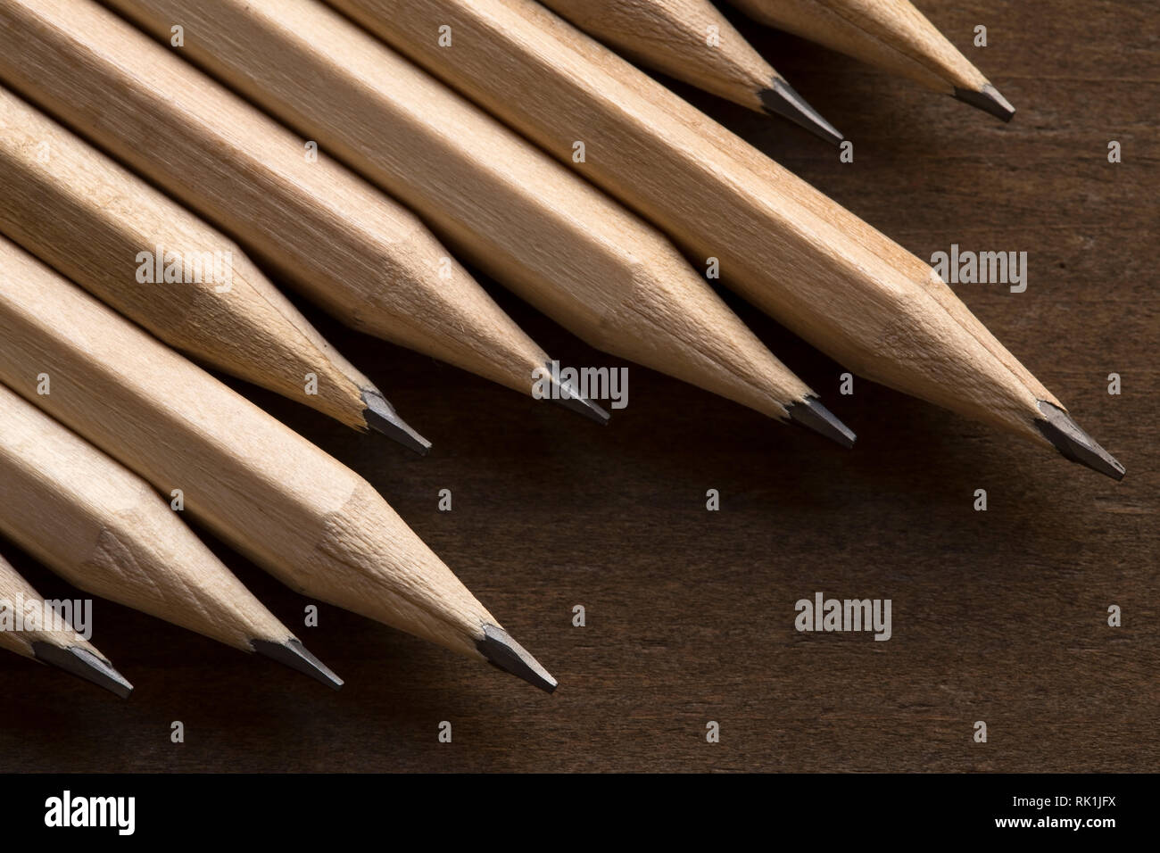 Wooden pencils on brown background Stock Photo