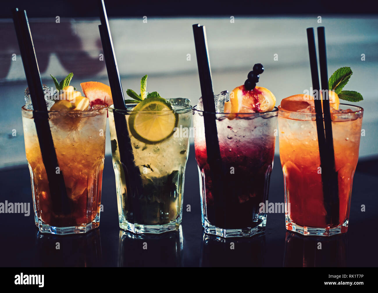 A full measure of bars. Cocktail drinks served in glasses with straws