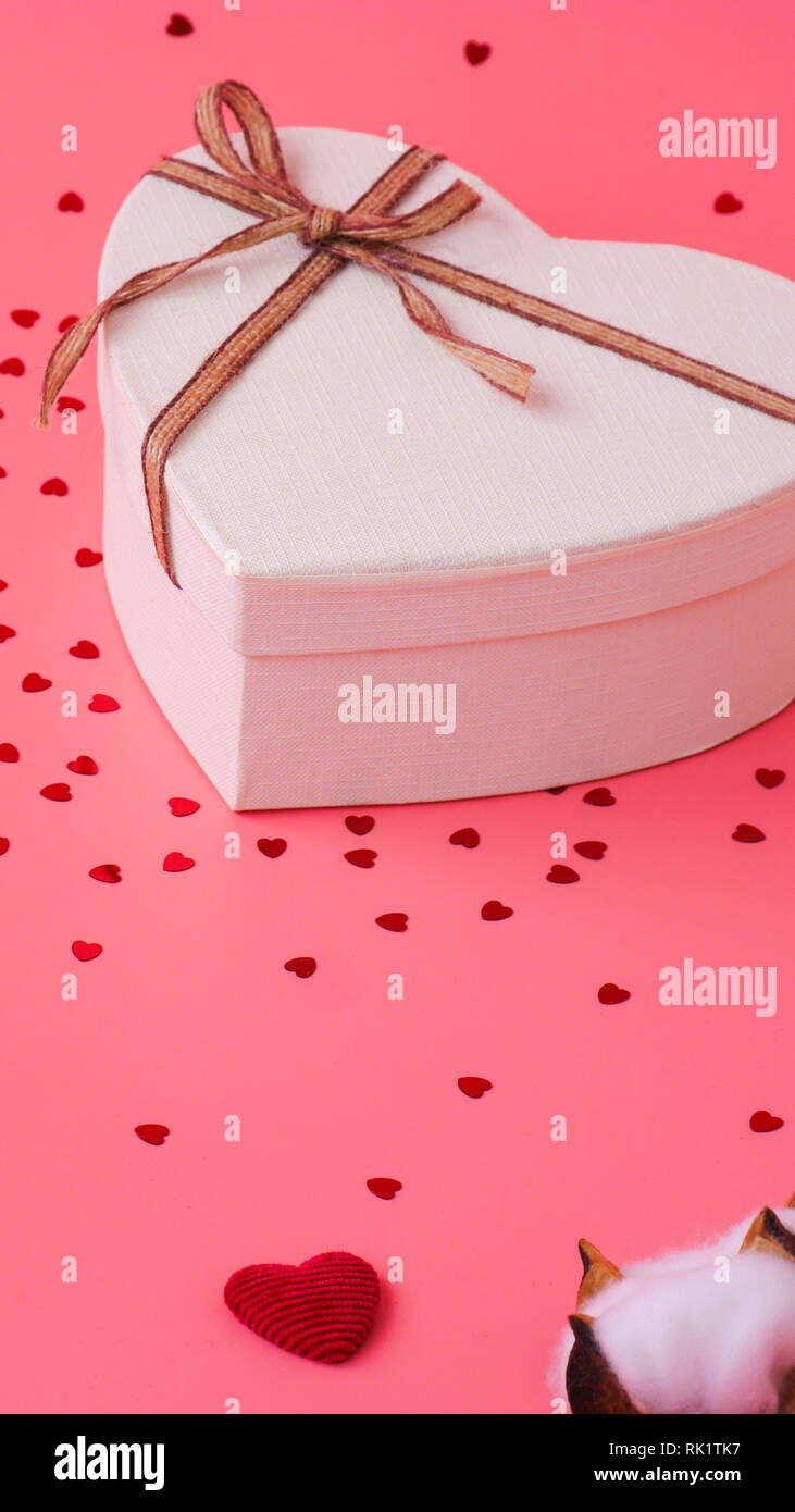 St. Valentine day background. Gift box with gold ribbon and lights on a ...