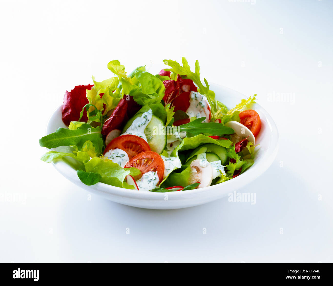 Lettuce Salad With Slices Of Radish Cucumber Tomato And Dressing In A Bowl Isolated On White Background With Copy Space Stock Photo Alamy