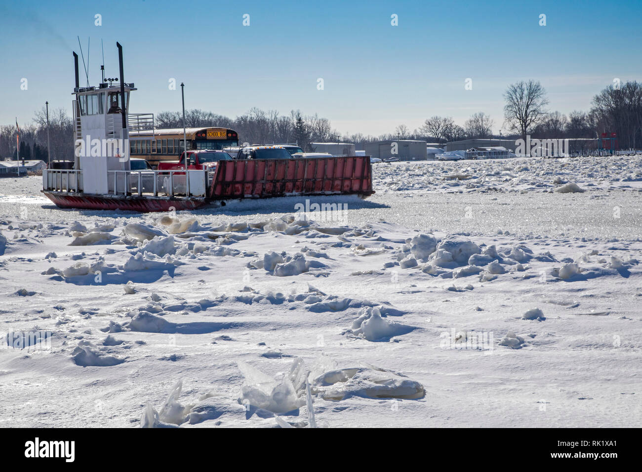 Algonac, Michigan - A car ferry sails through the ice-filled St. Clair River between Harsens Island and the Michigan mainland. Stock Photo