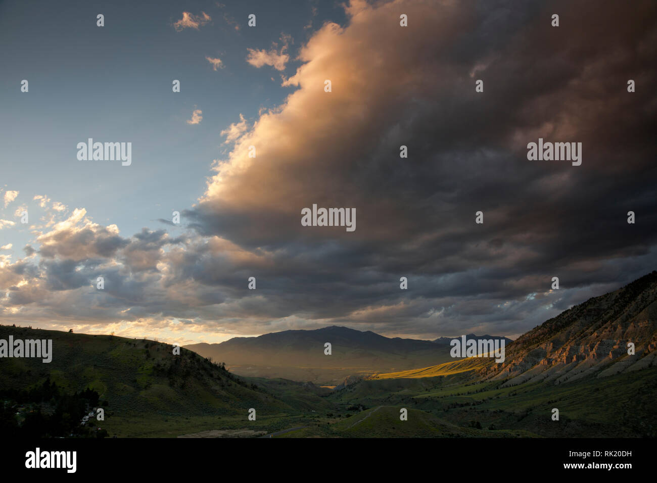 WY03381-00...WYOMING - View from Mammoth Hot Spring in Yellowstone National Park down the Gardner River gorge to the town of Gardiner at sunset. Stock Photo