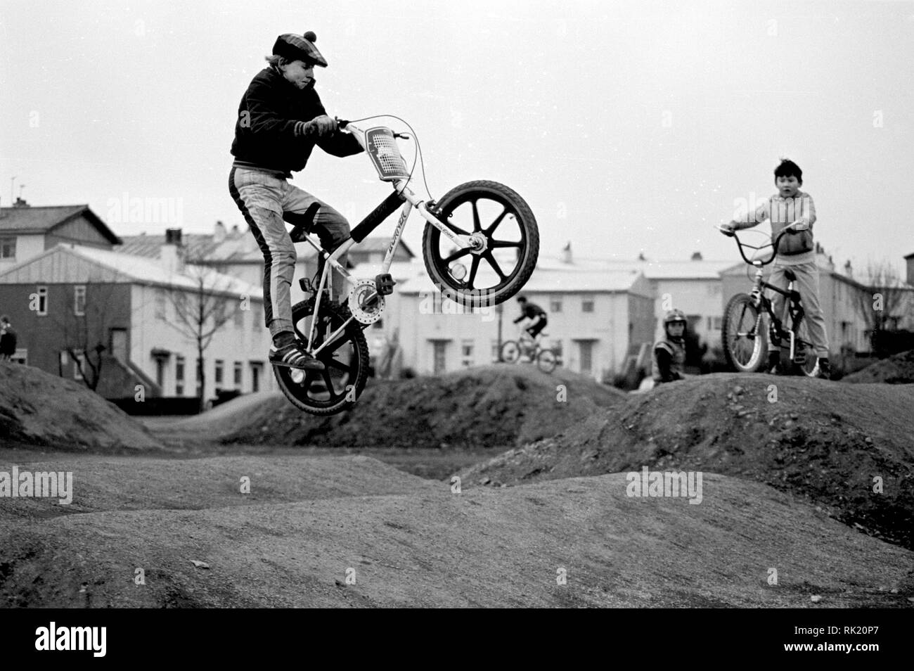 The new BMX Track at Drumry, Clydebank, 17th February 1985. The track was really only piles of dirt but the boys loved it. They were very good at the stunts. Taking off. Flying high. Fun Times. A great time was had by one and all. Stock Photo