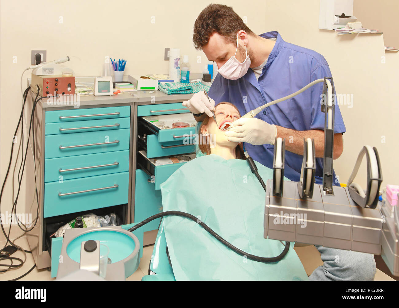 Dentist doctor drilling tooth in dental clinic Stock Photo - Alamy