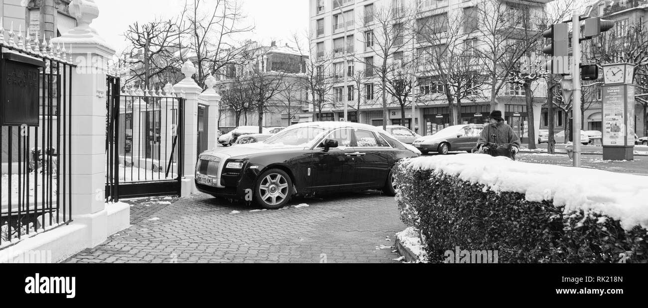 STRASBOURG, FRANCE - MAR 18, 2018: Wide image of new Luxury Rolls-Royce limousine black silver car on French Allee de la Robertsau preparing to enter parking - black and white image Stock Photo