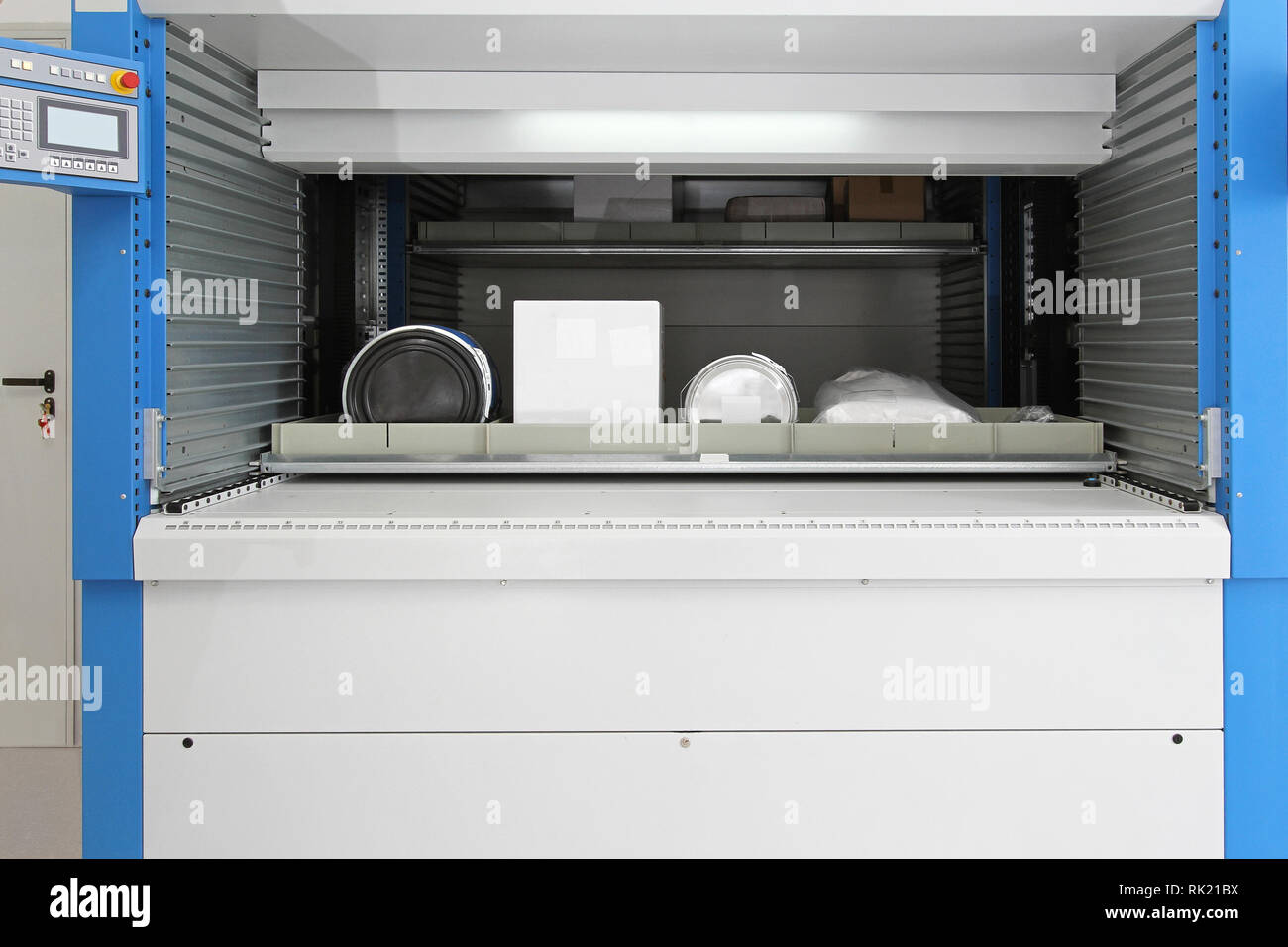 Open vertical carousel with tray goods in warehouse Stock Photo - Alamy