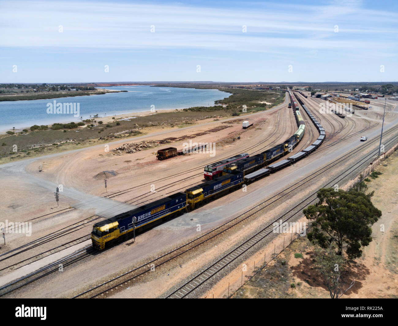 Aerial of freight train leaving Spencer Junction Rail Yard Port Augusta South Australia Stock Photo