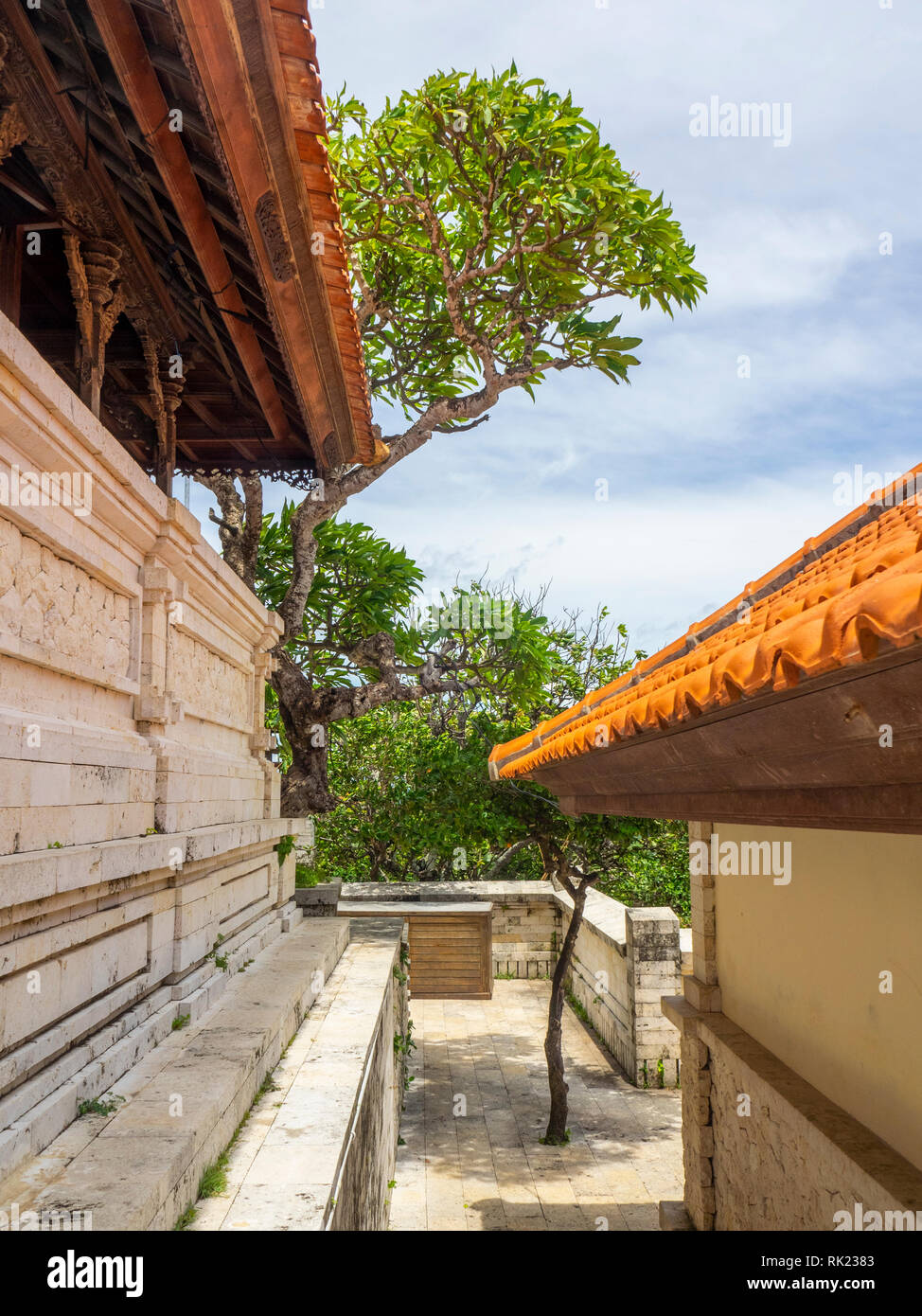 Terracotta roof and temple buildings at Uluwatu Temple compound, Bali Indonesia. Stock Photo