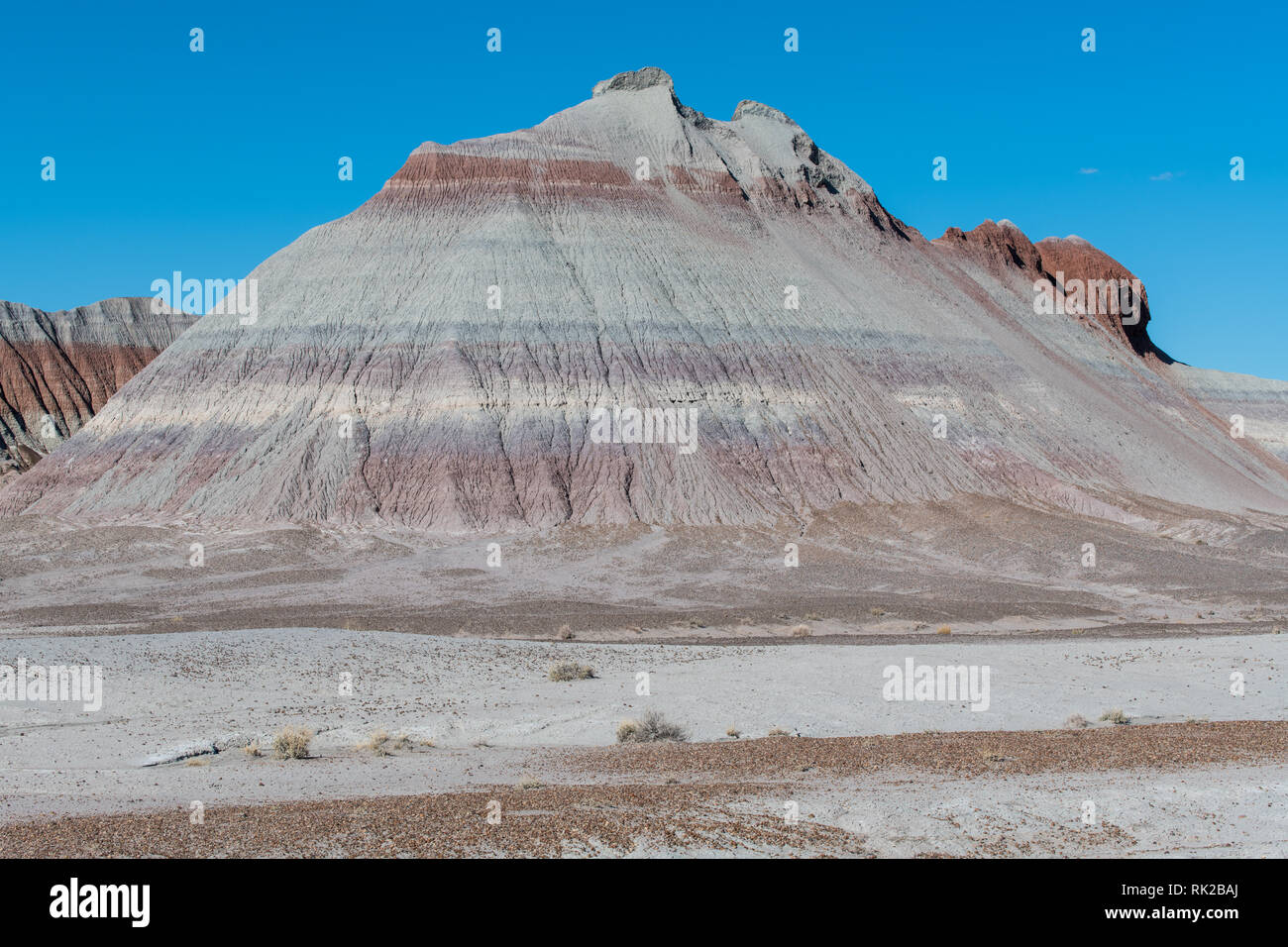 Colorful, barren desert rock formation with red, orange, and purple strata in Petrified Forest National Park, Arizona Stock Photo