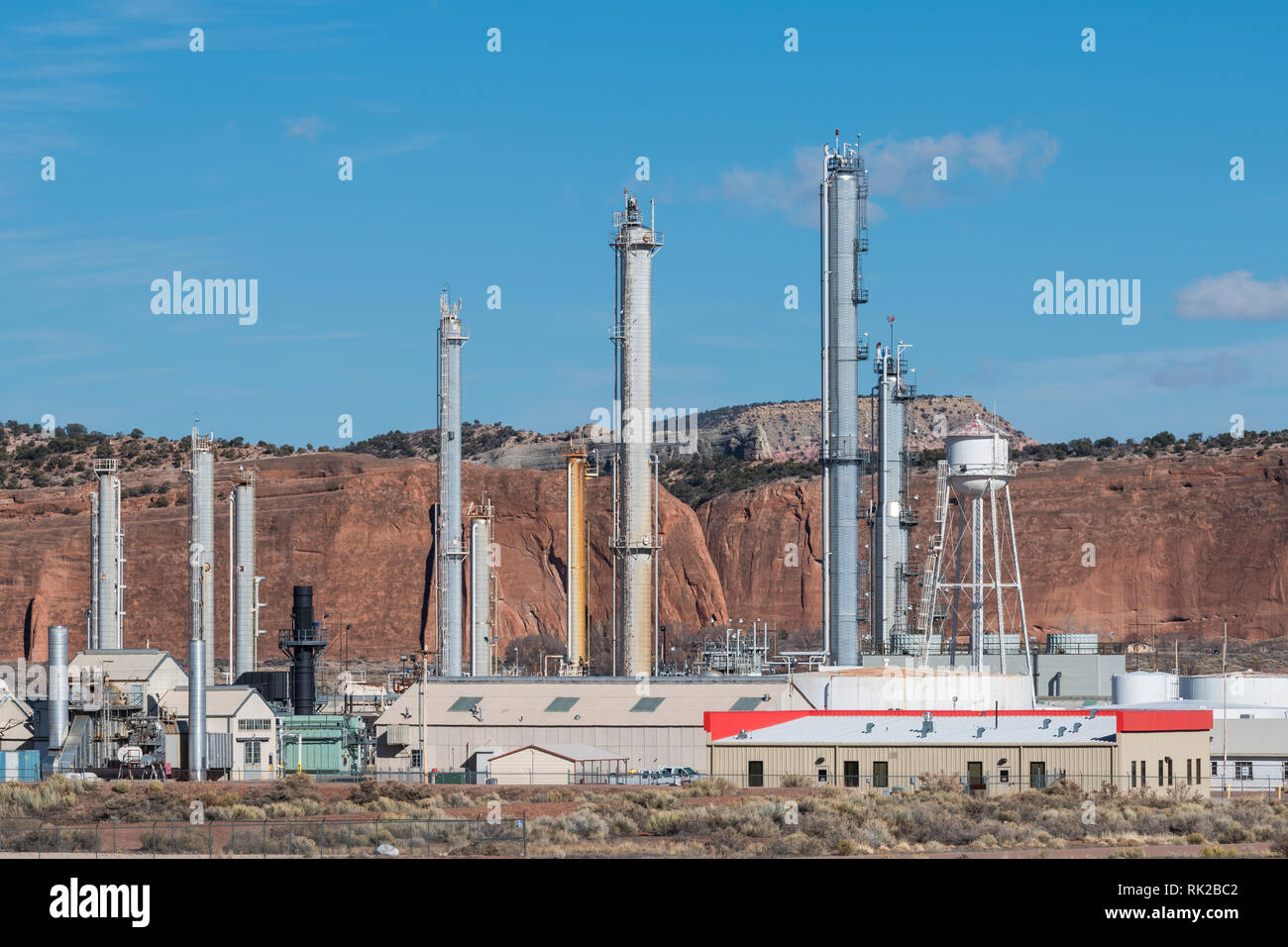 A natural gas refinery and red rock cliffs in the southwestern United States Stock Photo