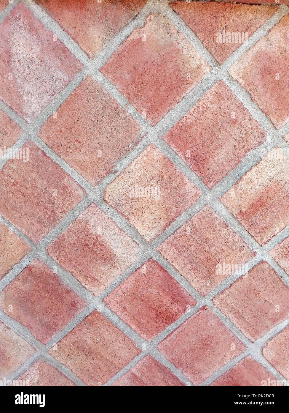 Wall of clay tiles in the shape of diamonds Stock Photo
