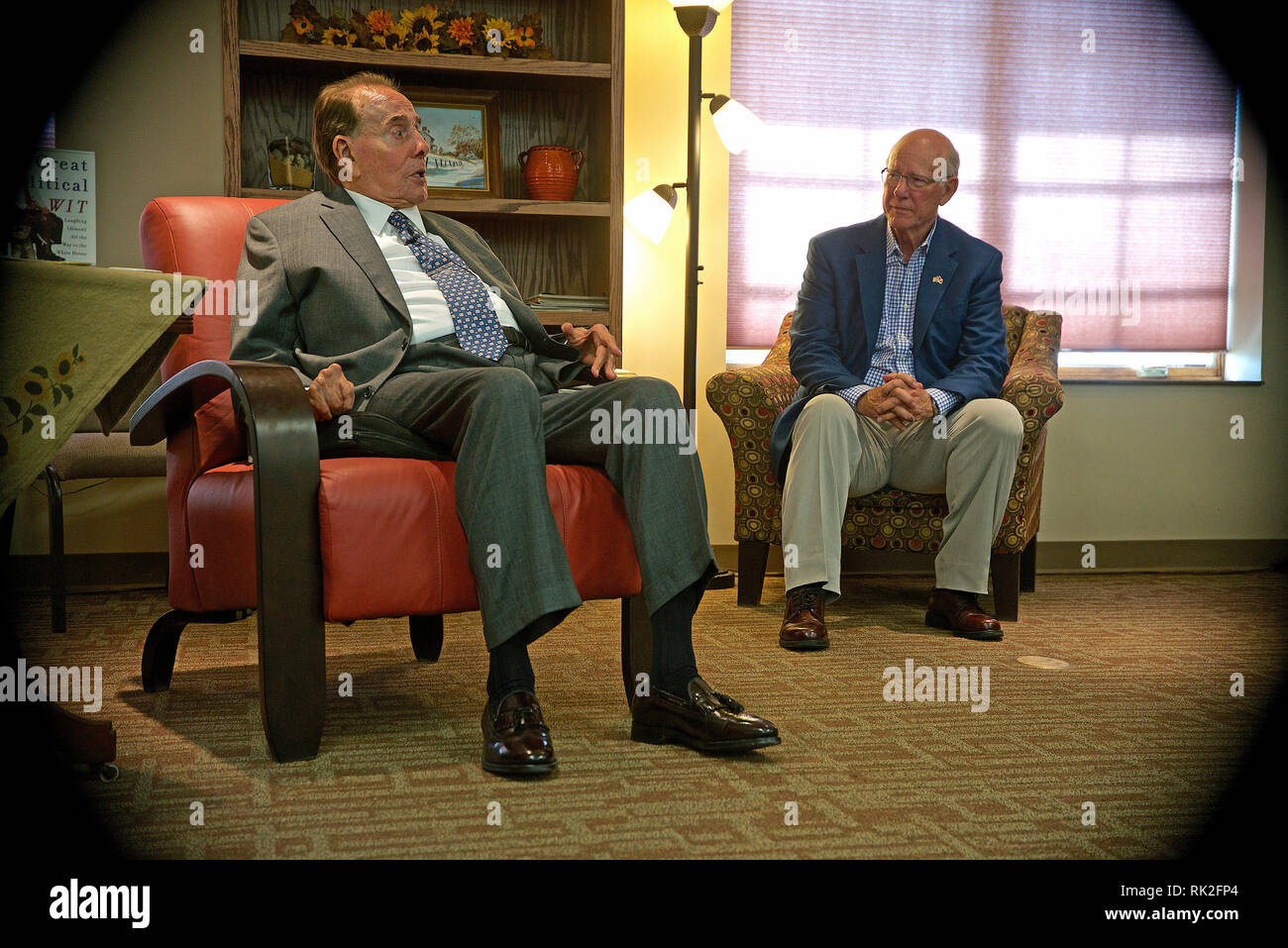 Greensburg, Kansas, USA,September 23, 2014 Former Senator Robert Dole visits with supporters at the Greensburg Senior Center, while Sen. Pat Roberts sits along side of him. Greensburg was destroyed by an F5 tornado in 2007 and now has been rebuilt with massive amount of help from FEMA. Stock Photo