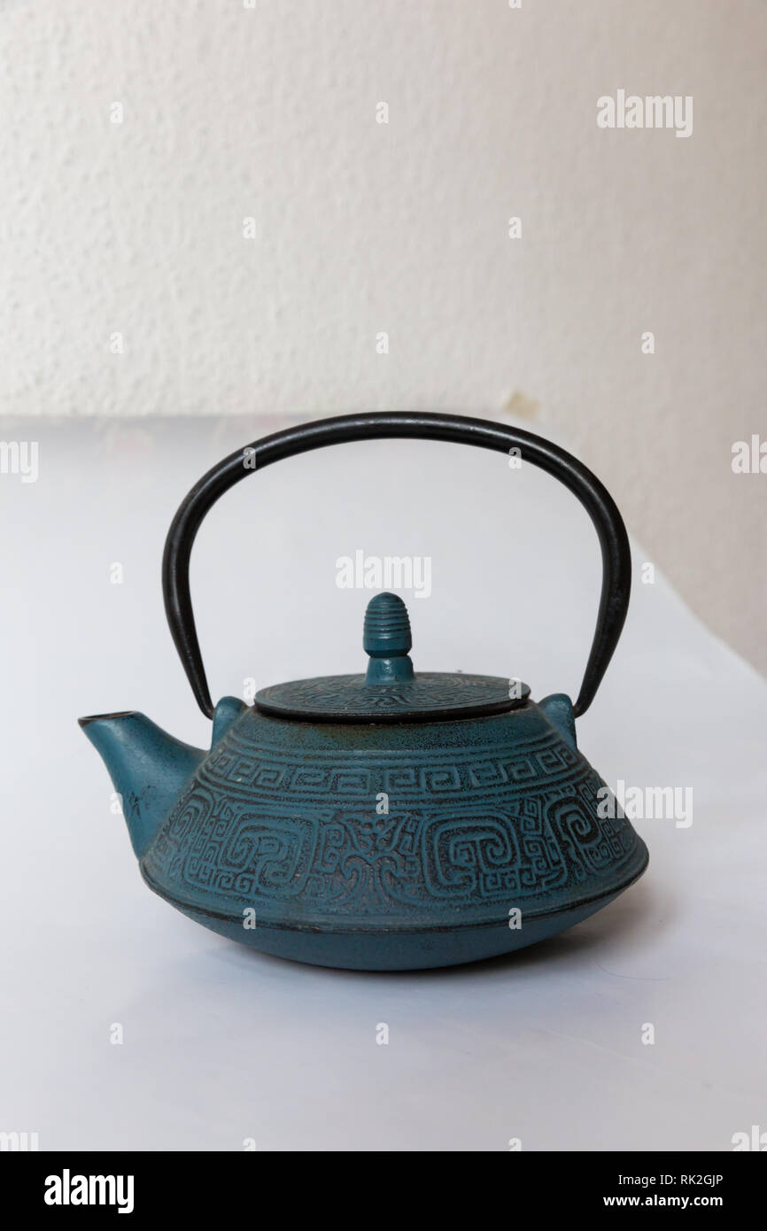 Blue traditional Chinese cast iron teapot on white background Stock