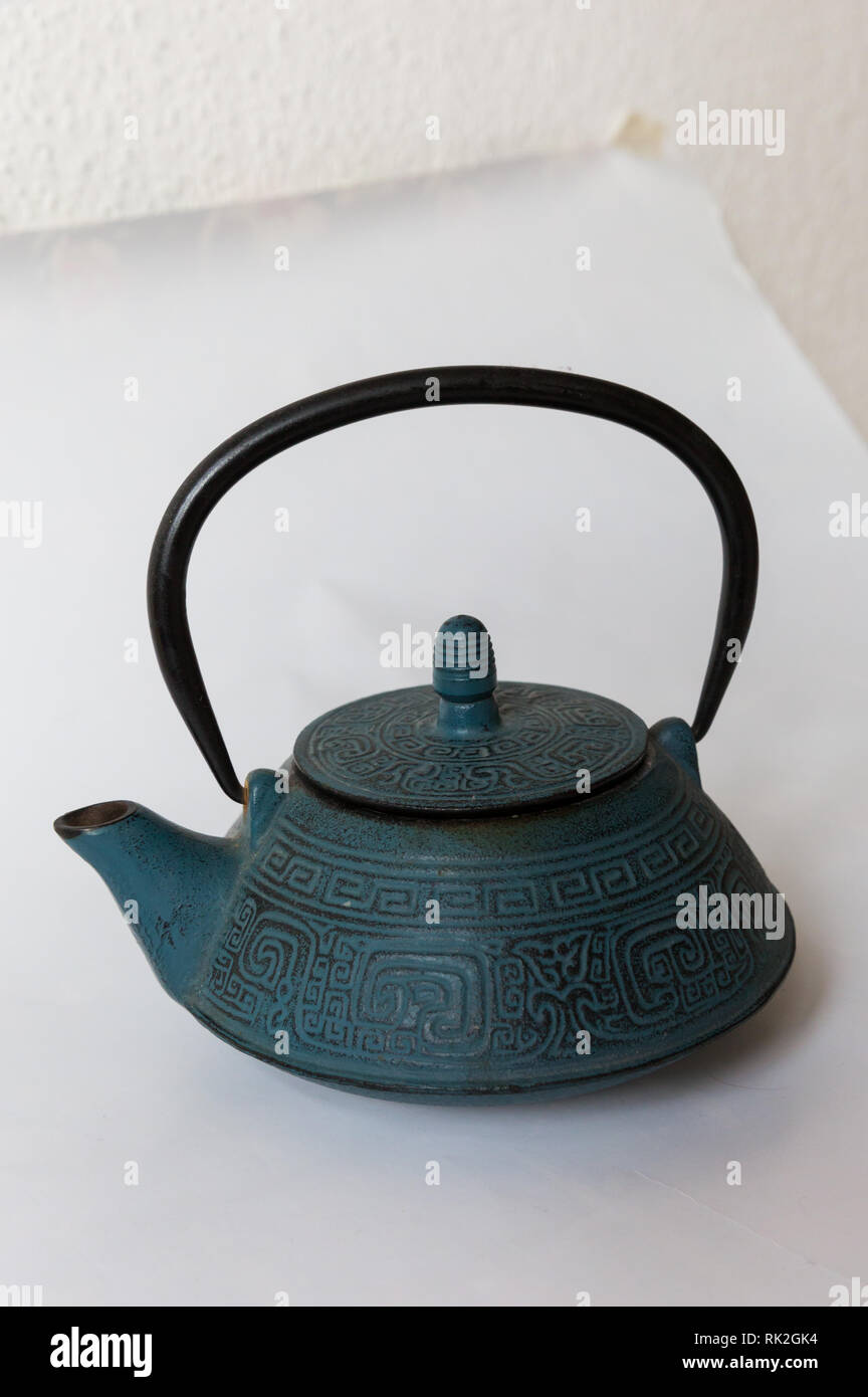 Blue traditional Chinese cast iron teapot on white background Stock