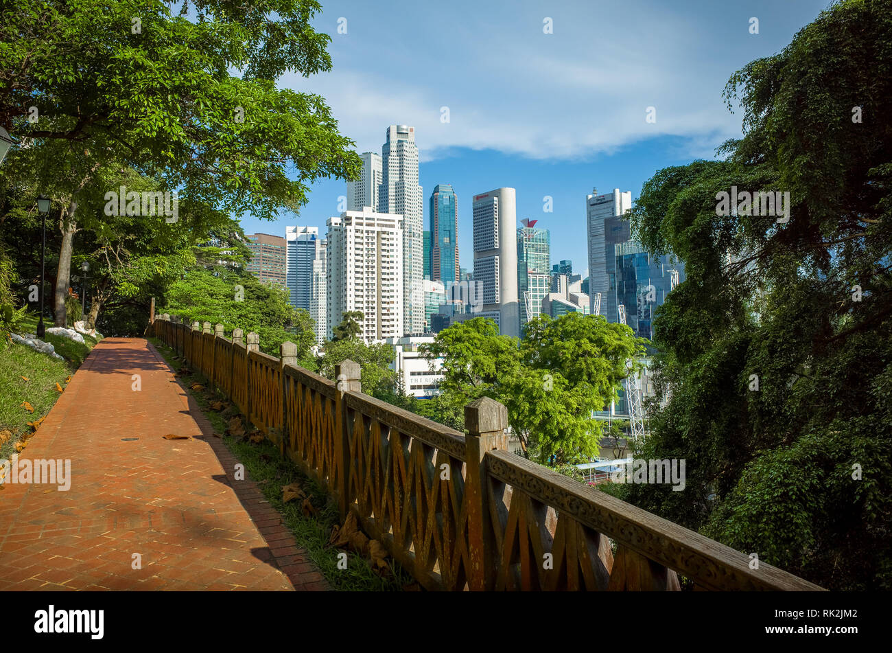 View of downtown buildings and skyline from Fort Canning Park walking path - Singapore Stock Photo