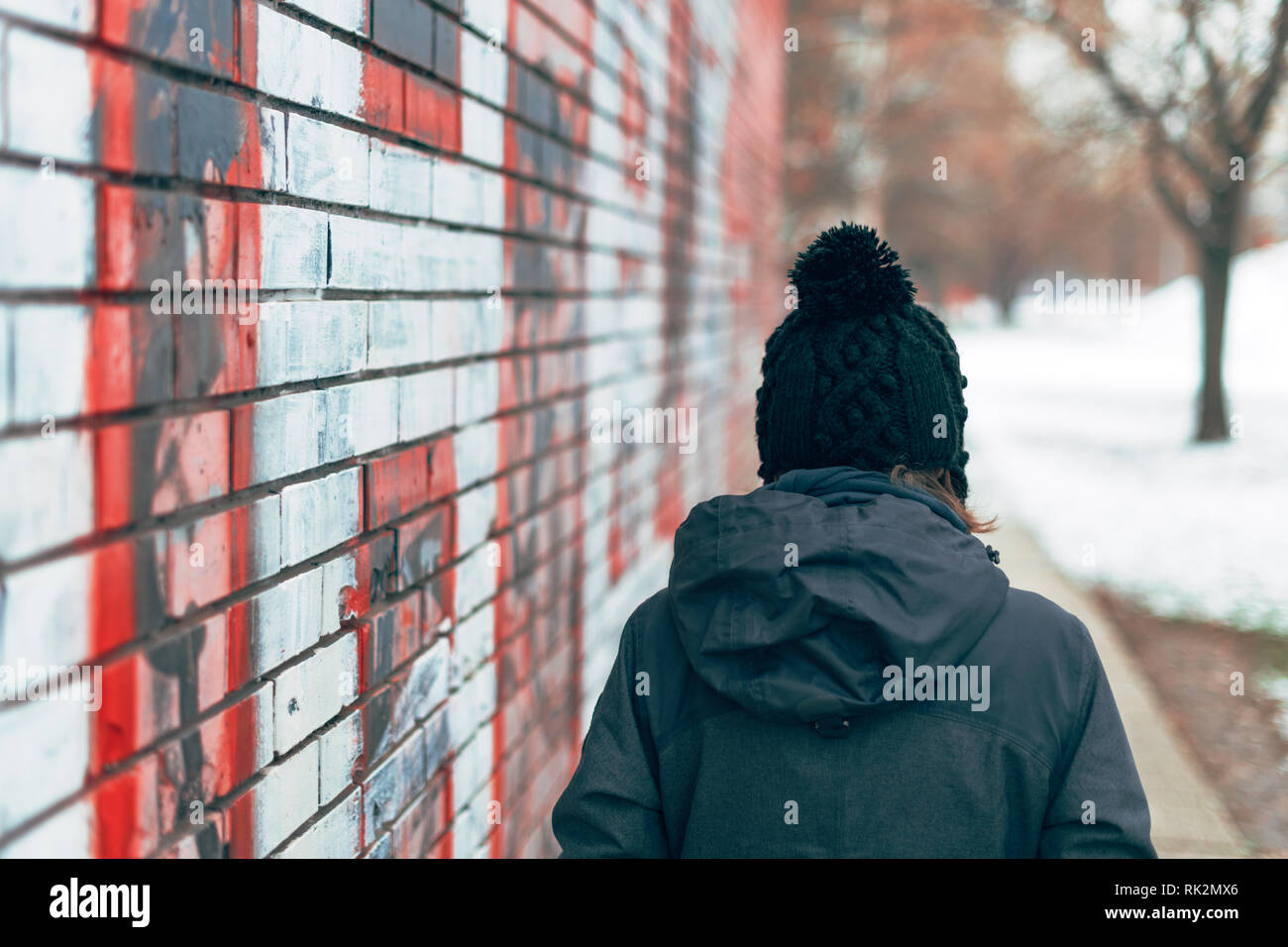 Woman alone walking winter sidewalk hi-res stock photography and images ...