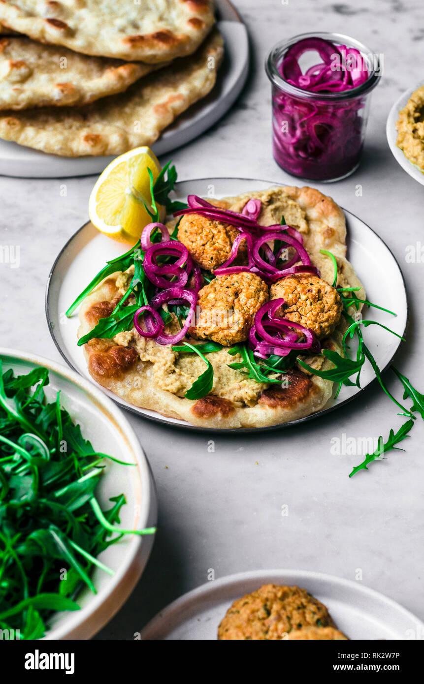 Red Lentil Falafel With Hummus Naan Greens And Pickled Onions Stock Photo Alamy