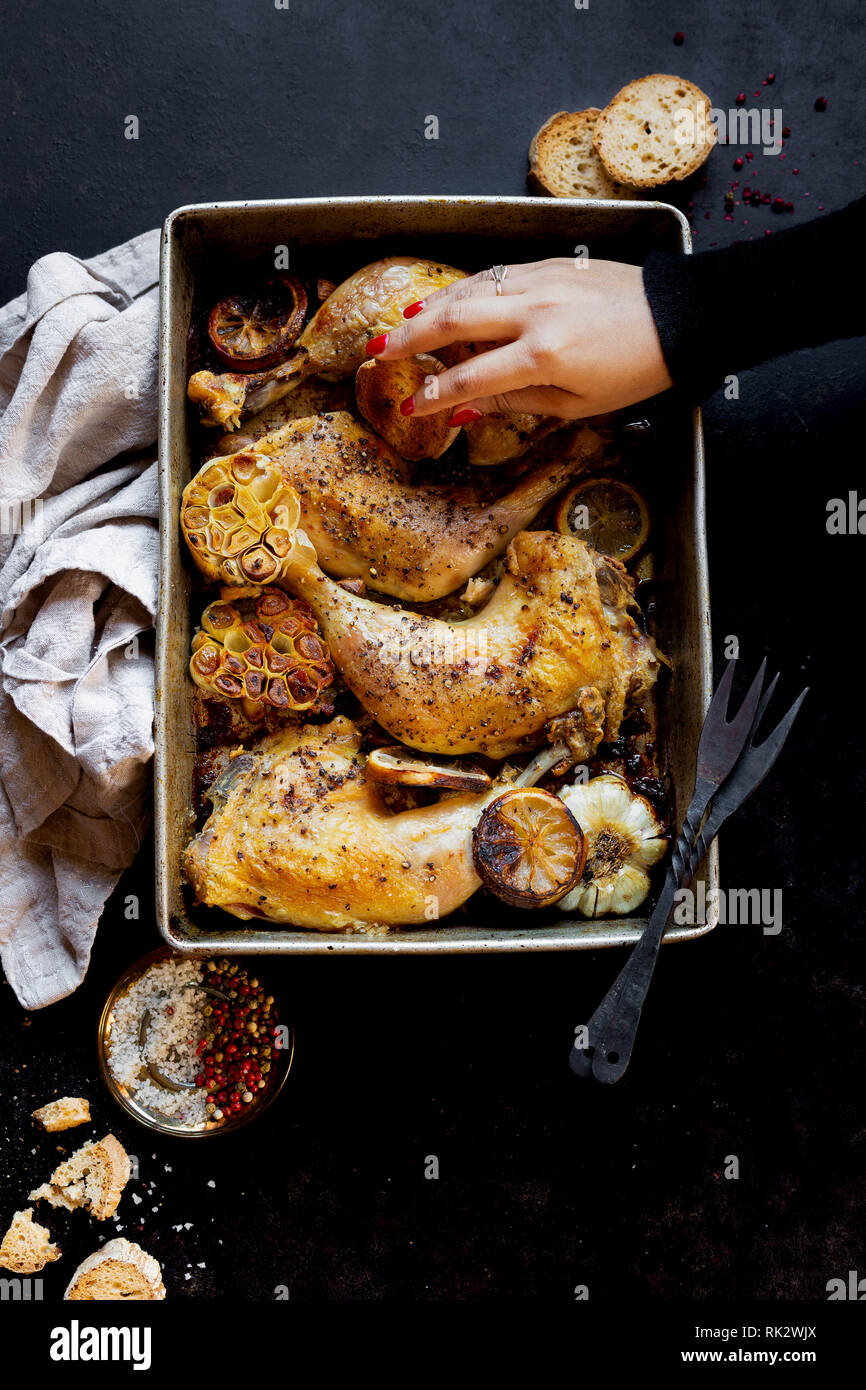 Roast Chicken Legs with sliced garlic Stock Photo Alamy
