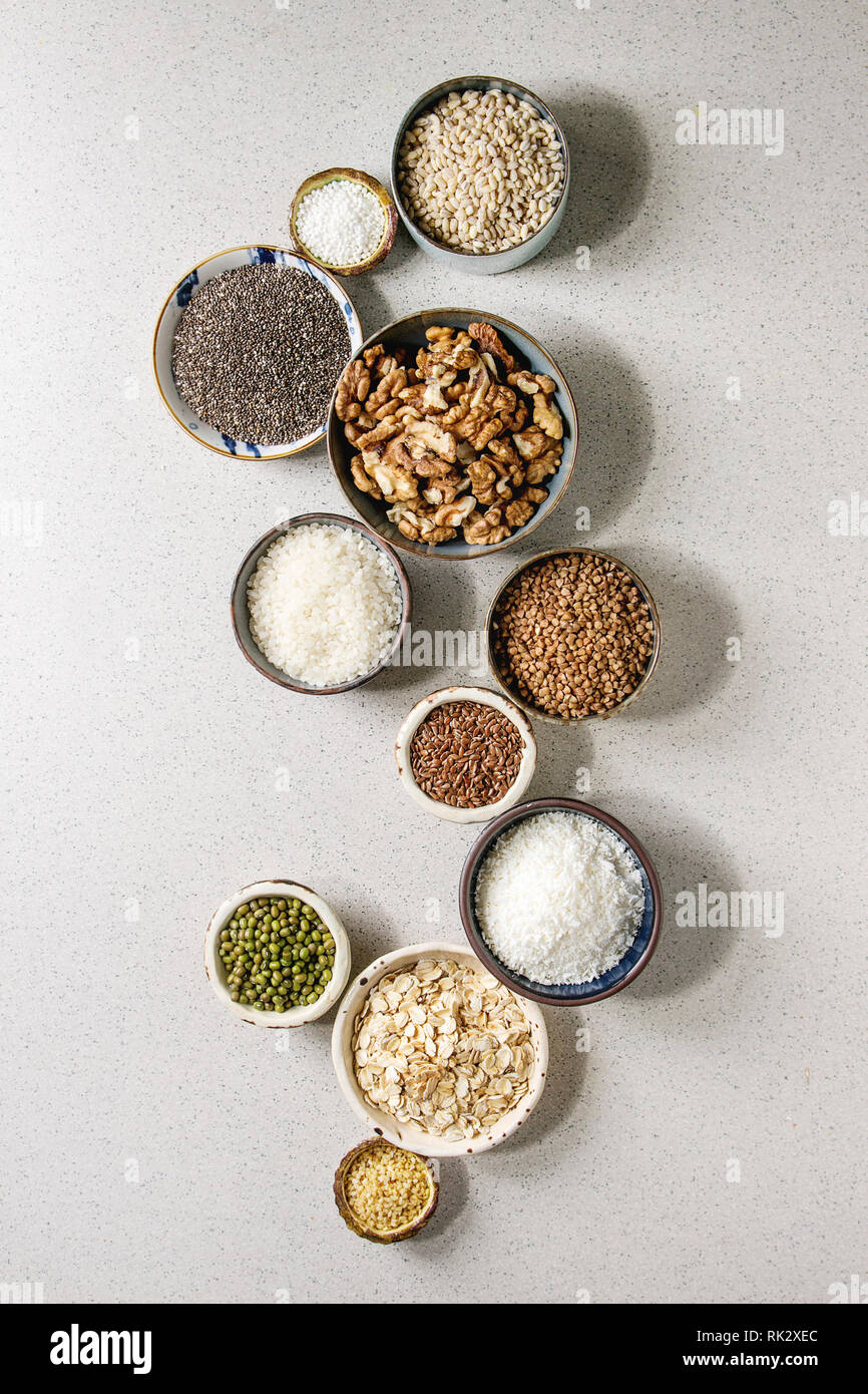 Variety of raw uncooked grains superfood cereal chia, linen, sesame, mung bean, walnuts, tapioca