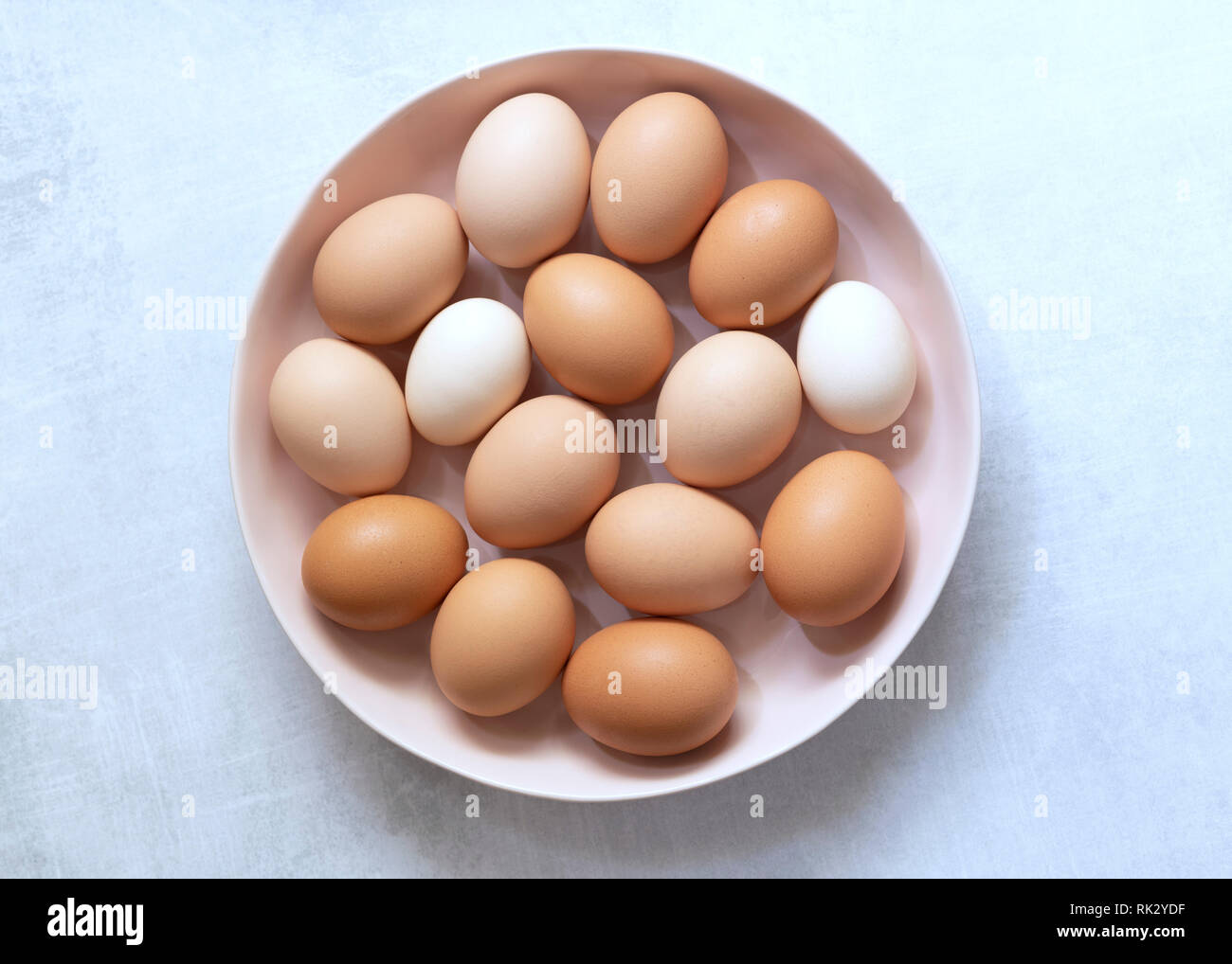 Brown and white eggs in a bowl. Stock Photo