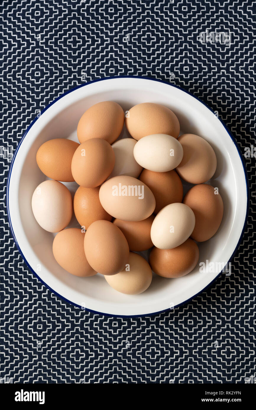 Brown, light brown and white eggs in a bowl. Stock Photo